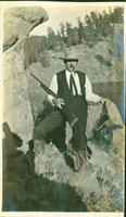 [Pipe smoking hunter with rifle and dead porcupine]