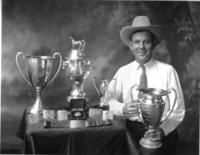 Chester Byers with some of his trick roping trophies - World Champion.