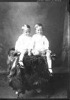 [Single portrait of two young Boys sitting on studio prop]