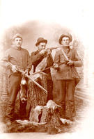 [3 hunters posed with rabbits]