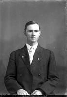 [Single portrait of a young Man sitting]