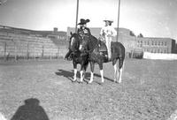 [Possibly Tad Lucas and unidentified cowgirl on horses]