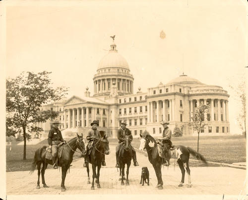"Left to right:  J. B. Ransom, R. G. Rayne, C. C. Beck and George W. Beck on the famed horse "Pinto" the only horse of 17 which completed the 20,352 mile trip. Dog, "Nip," who also finished the long trip."  on back, "Governor Earl Brewer of Miss April 27th 1914"