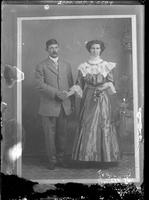 [Photograph of a photograph of a single portrait of a young Man and a young Woman]