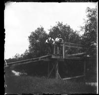 Father and Chas. on foot bridge over Little Bear Creek taken June 1898