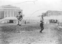 Two unidentified cowboys spinning loops simultaneously