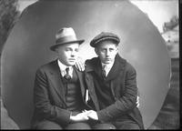 [Single portrait of two young Men sitting]