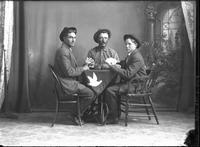 [Single portrait of three young Man sitting & playing cards]