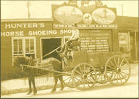 [Hunter's Horse Shoeing Shop billboards, horse-drawn farm wagon]