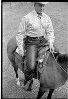 [Junior Eskew, sitting atop horse, poses for November 1969 Western Outfitter article]