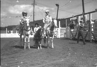 [Unidentified trio on horseback, cowboy, cowgirl, & female child