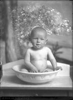 [Single portrait of an naked Infant in a tub]