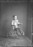 [Single portrait of a young Boy on a tricycle]