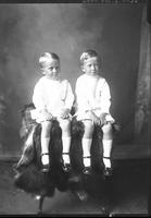 [Single portrait of two young Boys sitting on studio prop]