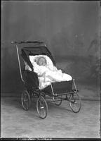 [Single portrait of an infant in a carriage]