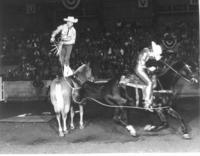 [Possibly Junior & Mary Louise doing a roping trick]