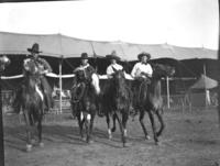 [Four unidentified cowboys on horses]