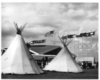 [Tipis, television mobile unit, museum, and flags]