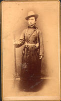 [Miss Annie Allbright standing with rifle]