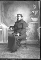 [Single portrait of aged pioneer woman sitting]