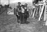 [Possibly George Mills & Jasbo Fulkerson on mules frame unidentified standing man]