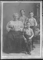 [Photograph of a photograph of a person and children]