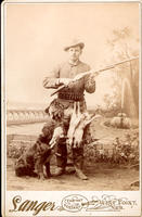 [Hunter with game hook belt, rifle, game and hunting dog]