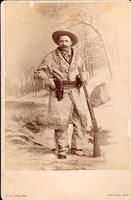 [Hunter in elaborate buckskin costume with model 1876 Winchester rifle and model 1873 Colt single action army revolver]