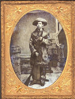 [Young man wearing fringed buckskin coat with rifle and fringed pouch]