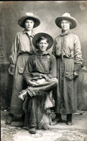 [Two costumed cowgirls and a farmer]
