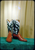 [Brown boots with black and white pattern]