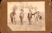 [Two cowboys with horses]