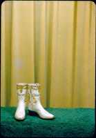 [White boots with a tan pattern and "Kathy"]