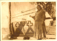[Navajo rug weaver with loom and unfinished rug]