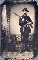 [Hunter with Winchester '73, two pistols and a dog]