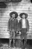 [Two cowboys with large cowboy hats]