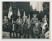 [Cowboys on horseback, appears to be a parade]