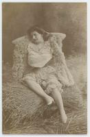 [Woman posed in ruffled dress and feather boa in faux outdoor setting] 605/8