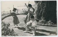 [Children dancing and playing instruments in traditional clothing]