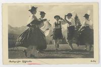 [German men and women dancing in traditional clothing]