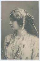 [Woman posed in elaborate jeweled headdress with pearls]