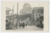 [Street scene with horse-drawn cart and streetcar]