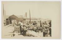 [Unidentified ship at busy wharf]