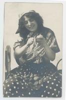 [Woman in European folk costume peeling potatoes]