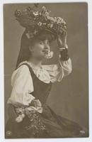 [Woman in European folk costume with two flower baskets]