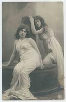 [Two women posed together in simple white gowns] 701/6