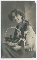 [Woman in European folk costume with basket of cherries]