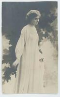 [Woman posed in simple white gown]