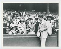 [Another man gets the attention of the woman while Tom Mix watches]