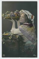 [Woman in Middle Eastern clothing with plate of fruit]